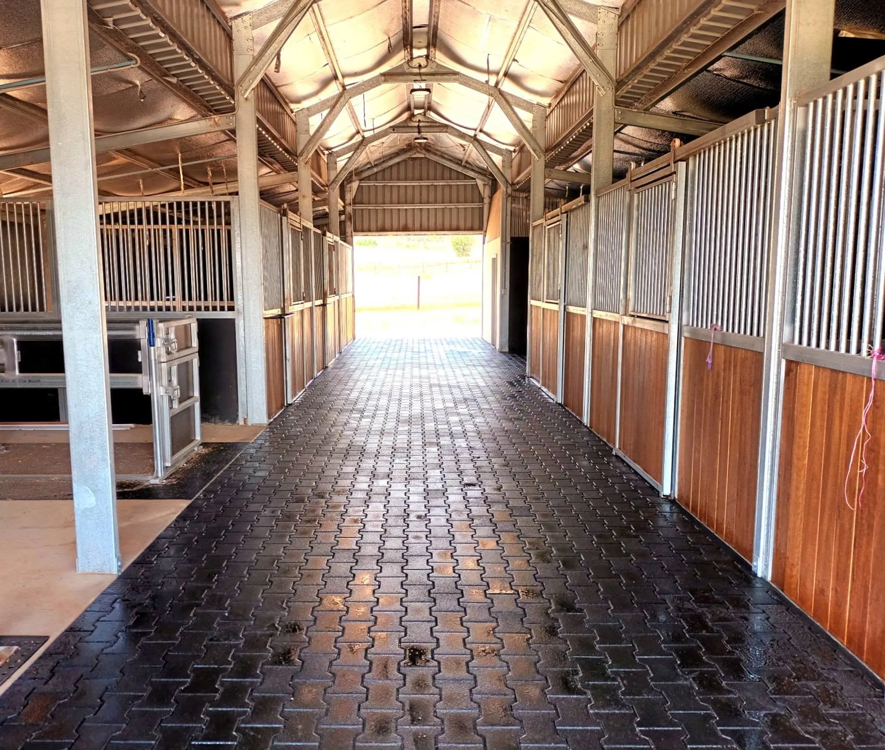 Brick paved stable breezeway after paving works were completed