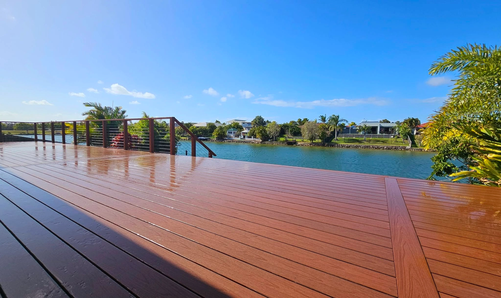 Timber deck extending to a canal edge with water views